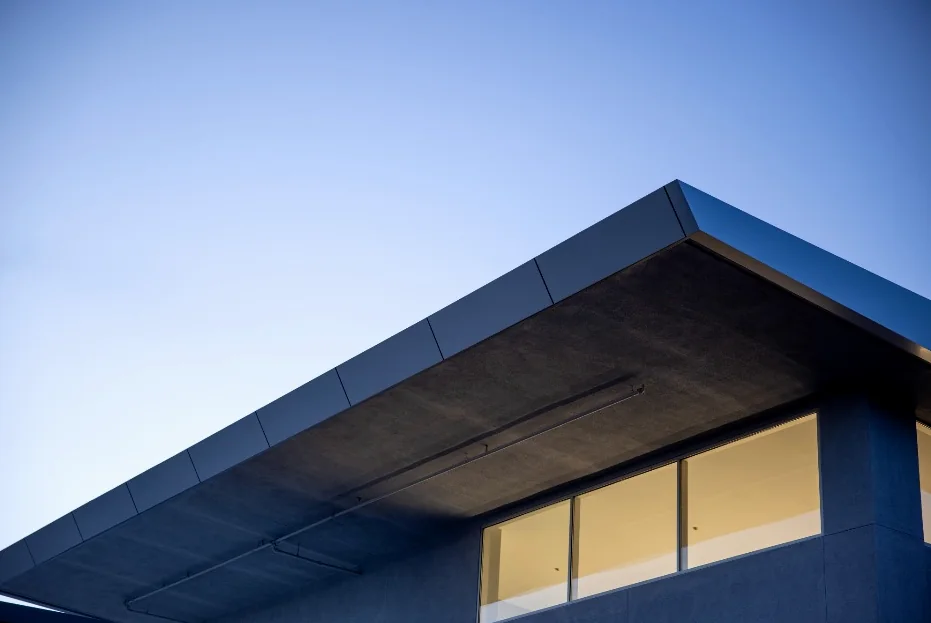 A modern roof overhang against a blue sky